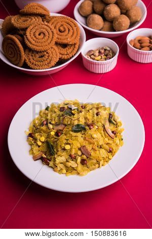 homemade tasty Diwali food or Diwali snacks or Diwali sweets like rava laddu, chakli, sev, shankar pale and chivda or chiwada with dry fruits in white bowls, favourite indian diwali recipe