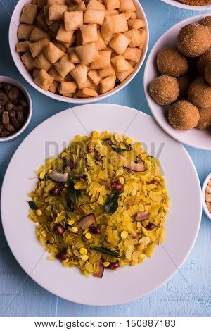 homemade tasty Diwali food or Diwali snacks or Diwali sweets like rava laddu, chakli, sev, shankar pale and chivda or chiwada with dry fruits in white bowls, favourite indian diwali recipe