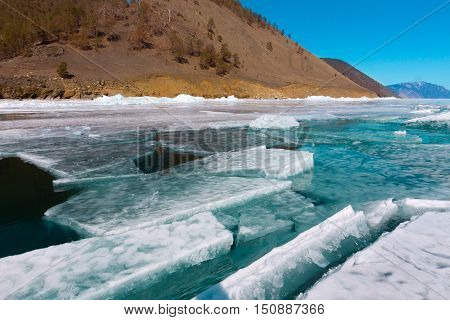 Clumps Of Blue Ice Floating In The Water In A Crack Near The Shore. Lake Baikal