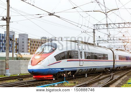 Modern hybrid electric locomotive Sapsan pulling a high-speed train on rails. Technical railway depot. Transport route St. Petersburg - Moscow Russia