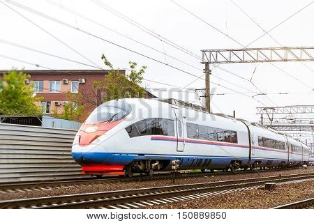 Modern hybrid electric locomotive Sapsan pulling high-speed train with railcars rzd on rails. Technical railway depot. Transport route St. Petersburg - Moscow Saint-Petersburg railway station Russia