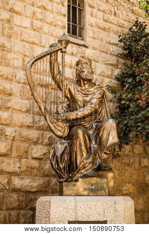 JERUSALEM ISRAEL - OCTOBER 5: The statue of King David playing the harp near entrance to his tomb on Mount Zion in Jerusalem Israel on October 5 2016