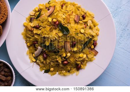 homemade tasty Diwali food or Diwali snacks or Diwali sweets like rava laddu, chakli, sev, shankar pale and chivda or chiwada with dry fruits in white bowls, favourite indian diwali recipe
