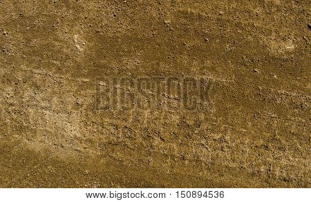 Texture of the soil, soil texture, nature background, ground, brown ground, sand, tire tracks