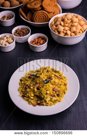 homemade tasty Diwali food or Diwali snacks or Diwali sweets like rava laddu, chakli, sev, shankar pale and chivda or chiwada with dry fruits in white bowls, favourite indian diwali recipe
