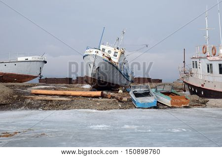 Ship And Fisher Boats On The Dock In Large Goloustnoye Village. Baikal Lake