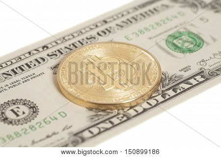 Golden bitcoin coin and one dollar banknote isolated on white