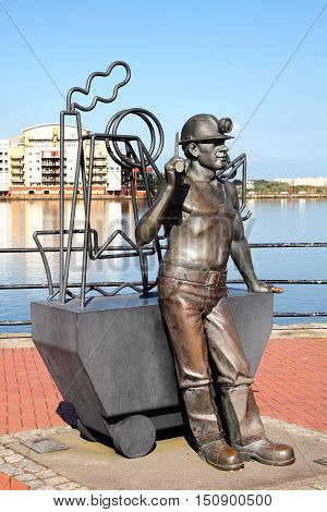 Cardiff, Wales, UK, September 14, 2016 :  From Pit to Port  sculpture by John Clinch and unveiled in 2005 which overlooks the Roath Basin in Cardiff Bay celebrating Welsh coal miners