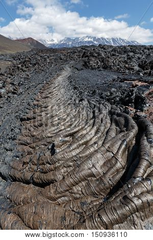 Volcanic landscape of Kamchatka: view of lava field volcanic eruption active Plosky Tolbachik Volcano on a clear sunny weather. Eurasia Russian Far East Kamchatka Peninsula Klyuchevskaya Group of Volcanoes.