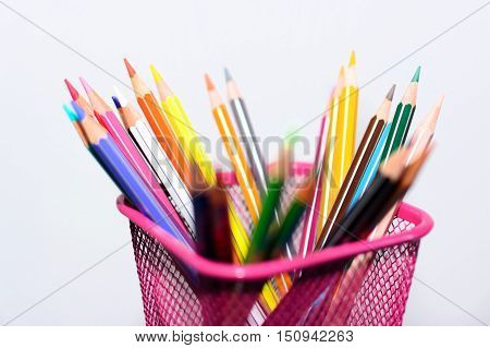 The colored pencils and sharp in penholder (blurred)