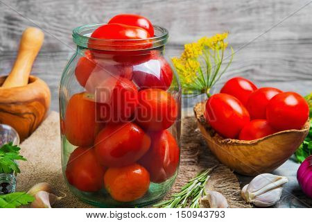 Canning pickling Preserving tomatoes herbs for canning pickling rosemary dill parsley pepper onion. Fresh vegetables for Preserving tomatoes gray wooden background.