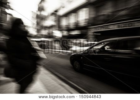Panning following a car a pass by on a street