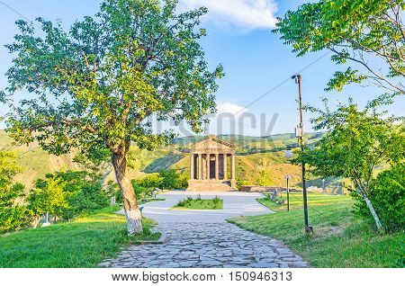 The shady path among the trees leads to the Garni Temple Kotayk Province Armenia.