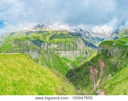The fast moving clouds hide the peaks of Greater Caucasus Mountain Range the weather on the Cross Pass is often changeable Gudauri Georgia.