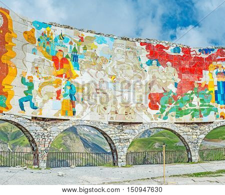 GUDAURI GEORGIA - JUNE 3 2016: The colorful Arch of Friendship of the Peoples on the Cross Pass is covered with tiles on June 3 in Gudauri.