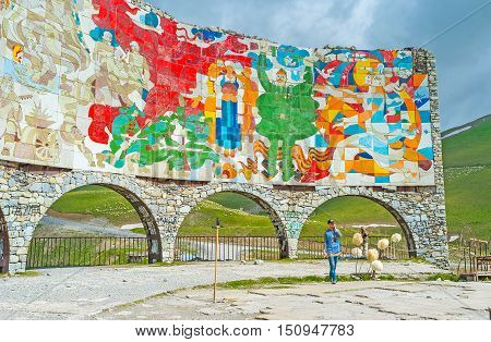 GUDAURI GEORGIA - JUNE 3 2016: The colorful Arch of Friendship of the Peoples located at the viewpoint on the Cross Pass on June 3 in Gudauri.