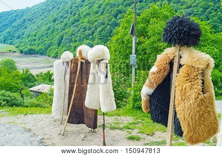 The Georgian shepherds' costume - the hat (papakha) and coat of sheep's fur are the best choice for cold mountain weather Ananuri Georgia.