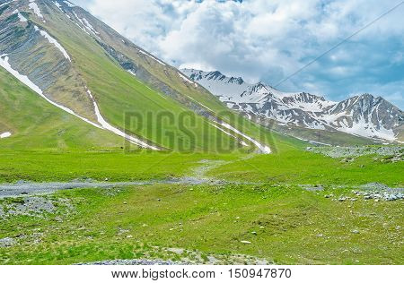 Even in summer the mountains of Greater Caucasus are covered with snowfields and clouds Gudauri Georgia.