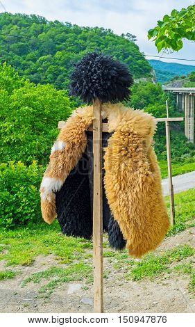 The traditional Georgian shepherds' dress - the hat (papakha) and coat of sheep's fur Ananuri Georgia.
