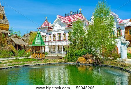 The tiny garden with a pond among the mansions museums and workshops of Izmailovsky Kremlin the Russian style cultural art and entertainment center Moscow Russia.