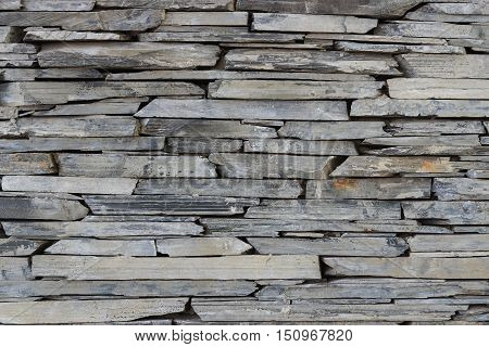 Layer of stone plate arranged as a wall / Stone wall background