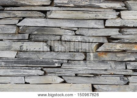 Layer of stone plate arranged as a wall / Stone wall background