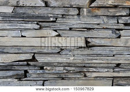 Layer of stone plate arranged as a wall / Stone wall background