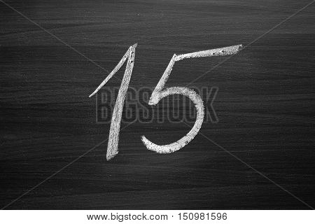 number fifteen enumeration written with a chalk on the blackboard