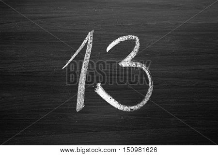 number thirteen enumeration written with a chalk on the blackboard