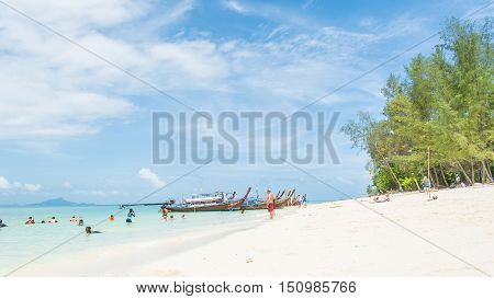 KRABI THAILAND - JUNE 1 2016: Unidentified tourists walk around and swim in the sea at Koh Poda in Krabi Thailand.