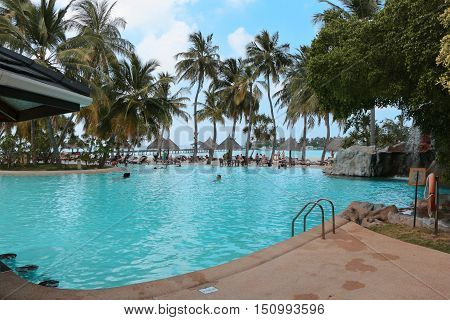 SUNISLAND, MALDIVES - FEBRUARY, 27, 2013: Swimmingpool on the beach with Palms