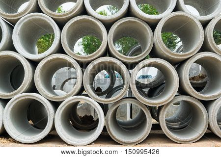 Concrete drainage pipes stacked on construction site