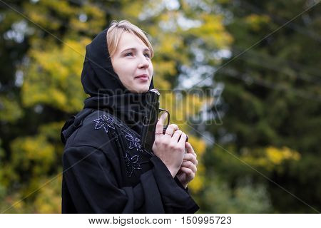 Muslim Woman With Arms In Autumn Day