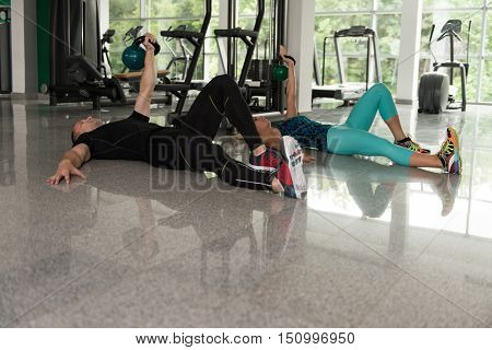 Man And Woman Kettle Bell Exercise