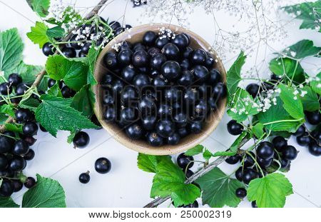 Berries Of A Tasty, Large Black Currant On A Table In A Small Plate