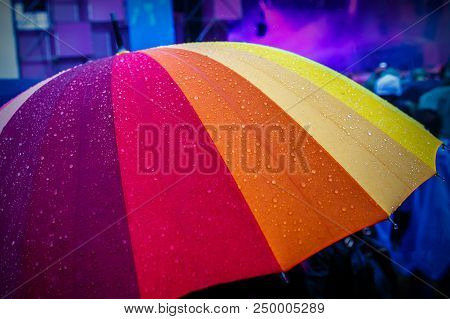 Rain Drops On Rainbow Multicolor Umbella. Close-up