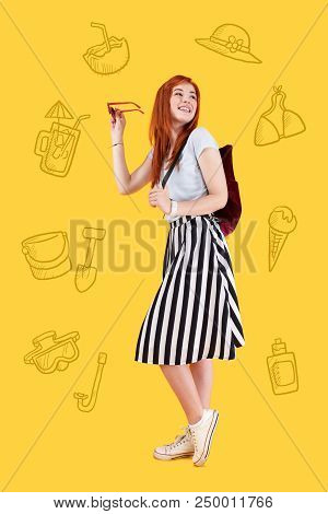 Seaside Rest. Positive Cheerful Student Standing With A Little Backpack And Smiling While Thinking A