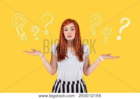 Many Questions. Diligent Serious Student Putting Her Hands Up And Thinking About Her Life After Grad