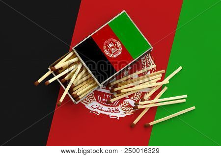 Afghanistan Flag Is Shown On An Open Matchbox, From Which Several Matches Fall And Lies On A Large F