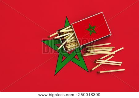 Morocco Flag  Is Shown On An Open Matchbox, From Which Several Matches Fall And Lies On A Large Flag
