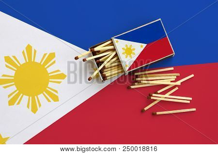 Philippines Flag  Is Shown On An Open Matchbox, From Which Several Matches Fall And Lies On A Large 