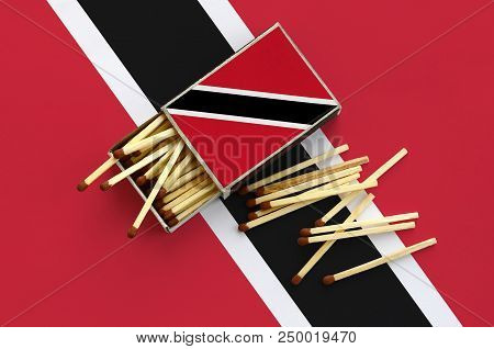 Trinidad And Tobago Flag  Is Shown On An Open Matchbox, From Which Several Matches Fall And Lies On 