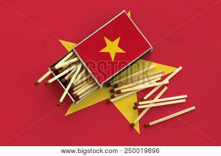 Vietnam Flag  Is Shown On An Open Matchbox, From Which Several Matches Fall And Lies On A Large Flag