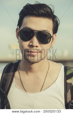 Close Up Face Of Younger Asian Man Wearing Sun Glasses Standing Outdoor