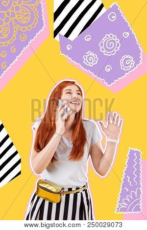 Waving. Cheerful Excited Designer Standing Near Her Bright Piece Of Art And Smiling While Talking On