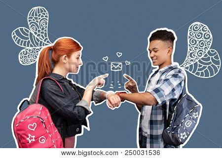 Quick Messages. Positive Progressive Young Friends Standing Opposite Each Other And Looking Interest