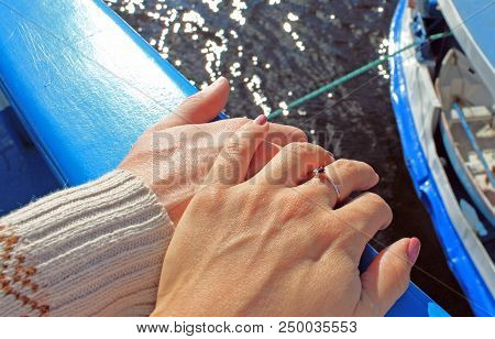 The Hands Of Men And Women During Travel By Ship