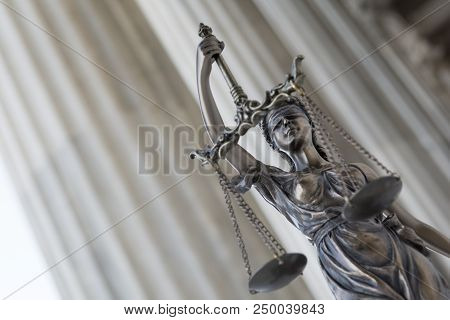 The Statue Of Justice Themis Or Iustitia, The Blindfolded Goddess Of Justice Against An Ionic Order 