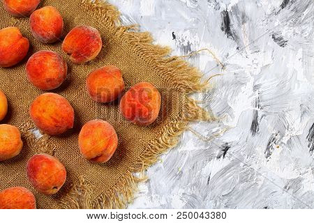A Group Of Ripe Peaches On The Old Fabric. Light Background. Fresh Peach Concept. Flat Lay. Copy Tex