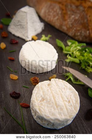 French Goats Cheeses And Bread On Background